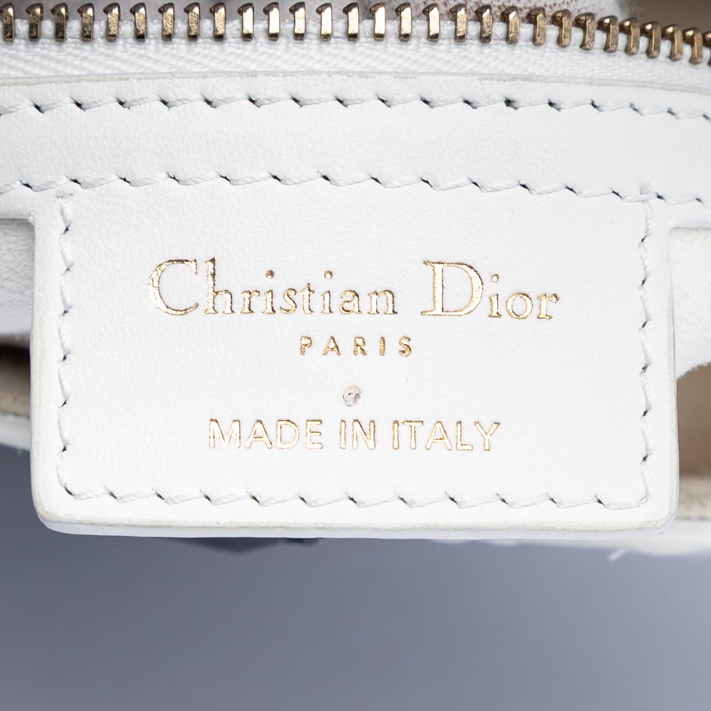 Perforated Oblique Embossed Calfskin Saddle Bag