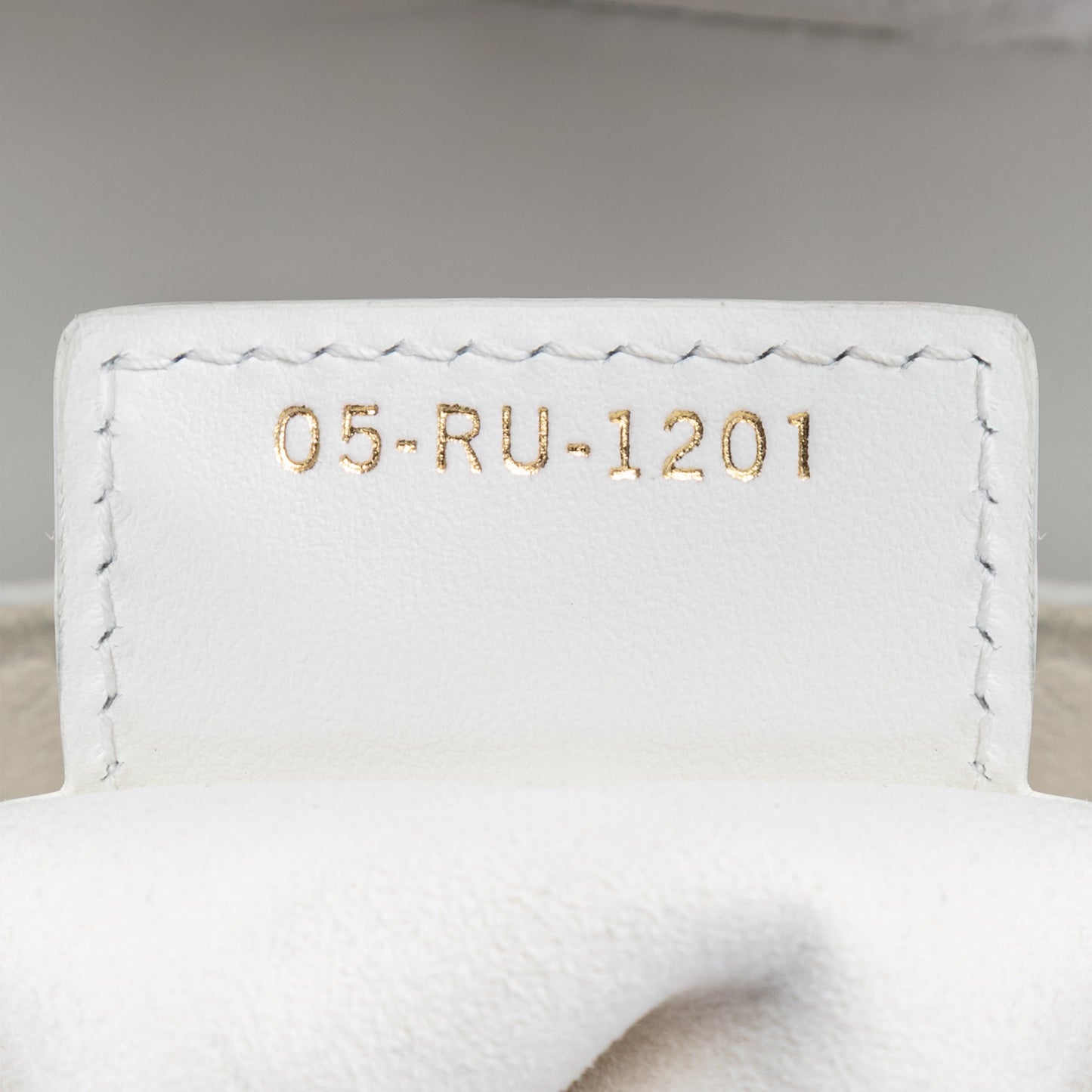 Perforated Oblique Embossed Calfskin Saddle Bag